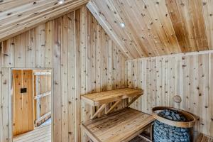 a wooden sauna with two wooden shelves in it at Log Cabin Fireplace Upper Valley - Wooded Chalet in Hartland