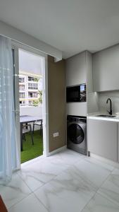 a kitchen with a sink and a table with a window at Las Americas 200 B apartment in Costa de Adeje