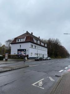 a large white building on the side of a street at Pott Rooms & Flats in Gelsenkirchen