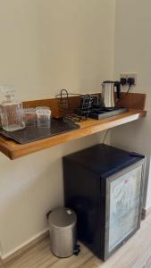 a kitchen with a counter with a stove and a microwave at Villa Carino Kilifi Kenya in Kilifi +4 photos