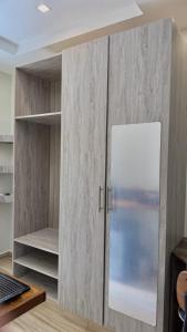 a cupboard with a white refrigerator in a room at Villa Carino Kilifi Kenya in Kilifi