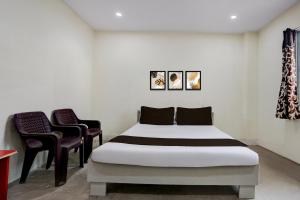 En eller flere senge i et værelse på SPOT ON by OYO Shubh Milan