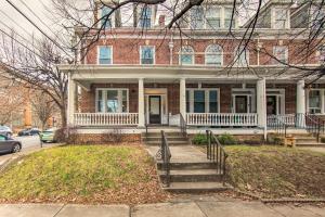 a red brick house with a staircase in front of it at Roomy Lancaster Home Walk to Dtwn and Hospital in Lancaster