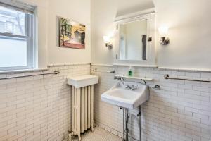 a white bathroom with a sink and a mirror at Roomy Lancaster Home Walk to Dtwn and Hospital in Lancaster +18 photos