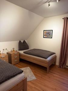 a bedroom with two beds in a attic at Ferienwohnung Grobbel in Schmallenberg +13 photos