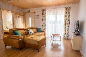 a living room with a couch and a table at Domki u Wojtka in Grywałd