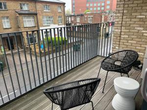 two chairs and a toilet on a balcony at Cozy Flat for 2 River of Thames with FREE Parking in Staines