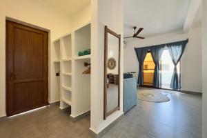 a hallway with a door and a mirror in a room at Shirley Boutique Hotel in Kiwengwa +48 photos