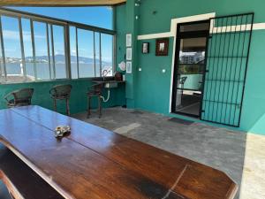 a table in a room with a view of the ocean at Casa Maria Mar in São José