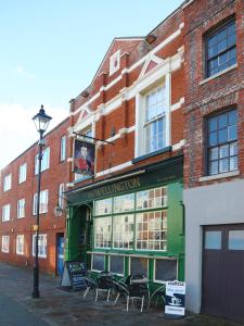 a building with tables and chairs in front of it at The Wellington Restaurant and Bar in Portsmouth