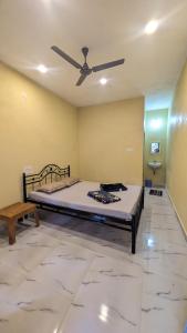a bedroom with a bed and a ceiling fan at Main beach stay in Gokarna