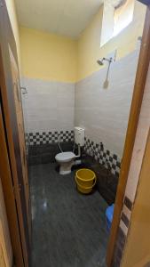 a bathroom with a toilet and a shower at Main beach stay in Gokarna