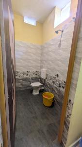a bathroom with a toilet and a shower at Main beach stay in Gokarna