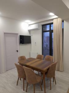 a dining room with a table and chairs at Apartment in Rustavi