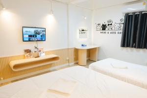 a room with a bed and a tv on the wall at Amphawa Horse Farm Resort in Ban Bang Khan Taek (1) +203 photos