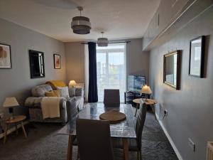 a living room with a couch and a table at Home Sweet Home, Calverley Court Apartment Home in West Midlands, England in Parkside