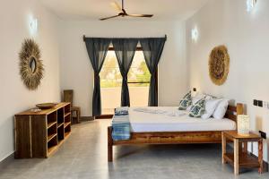 a bedroom with a bed and a window at Shirley Boutique Hotel in Kiwengwa
