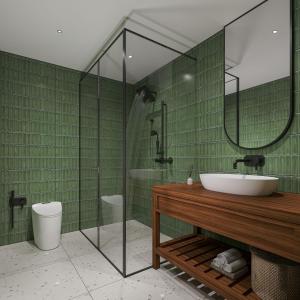 a green bathroom with a sink and a shower at Aayovea Hotels & Resorts, Ayodhya in Ayodhya