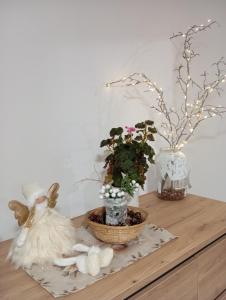 a wooden shelf with flowers and vases on it at Vila Veles in Dolný Kubín +27 photos