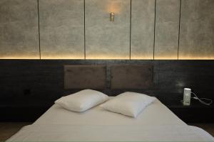 two white pillows sitting on a bed in a room at Hotel Antika in Peje