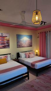 Ένα ή περισσότερα κρεβάτια σε δωμάτιο στο Bayside & Beach Inn Langkawi