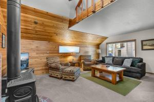 a living room with a fireplace and a stove at Leisure Lane 4 in Sunriver