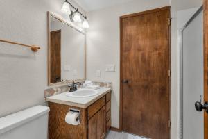 a bathroom with a sink and a wooden door at Leisure Lane 4 in Sunriver +31 photos