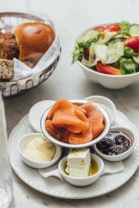 a table with plates of food and bowls of food at Cucu Hotel in Tel Aviv +39 photos