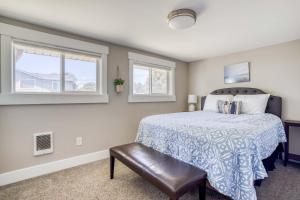a bedroom with a bed and two windows at Coastal Livin in Beverly Beach