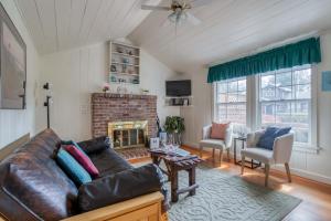 a living room with a couch and a fireplace at Cathys Cottage in Cannon Beach