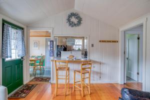 a kitchen with a counter and chairs in a room at Cathys Cottage in Cannon Beach