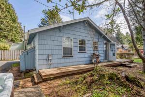 a small blue house with a wooden porch at Cathys Cottage in Cannon Beach