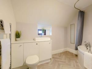 a white bathroom with a toilet and a sink at 2 Bed in Newton-on-Rawcliffe 88957 in Newton +32 photos