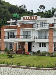 a building with a lawn in front of it at Pahaad Ko Ghaar in Nagarkot