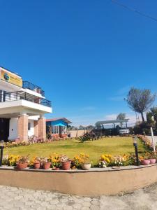 a row of flowers in front of a building at Pahaad Ko Ghaar in Nagarkot