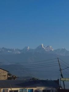 a view of some snow capped mountains in the distance at Pahaad Ko Ghaar in Nagarkot