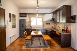 a kitchen with a wooden table and a kitchen with a dining room at aEN Fine Living in Edessa