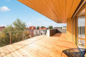 a balcony with a wooden deck with a view at Baltic Sands in Hel