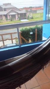 a window with a view of a yard at Casa paulo e nubia in Imbé