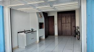 a hallway of a house with a door and a bike at Casa paulo e nubia in Imbé