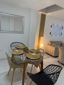 a dining room with a glass table and chairs at New Central Apartment 101 in Ocaña +9 photos