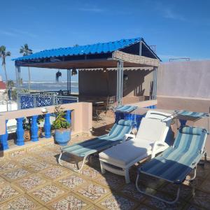 a group of chairs sitting on a patio near the beach at riad la citadelle in El Jadida