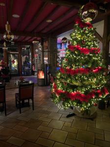 a christmas tree in a shopping center with at Hotel Val De La Cascade in Stavelot