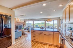 a kitchen with a large island and a living room at Twin Rocks Retreat in Rockaway Beach