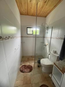 a bathroom with a toilet and a window at Casa Bella Vista 1 Paraguay in Bella Vista +21 photos