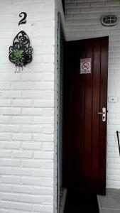 a door to a house with a no parking sign on it at Casa do Point in Saquarema