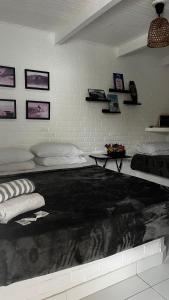 a room with a bed with a blanket on it at Casa do Point in Saquarema