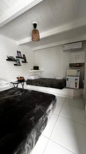 a room with two beds and a table in it at Casa do Point in Saquarema +84 photos