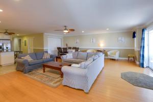 a living room with two couches and a table at Spacious Wildwood Townhome with Covered Balcony in Wildwood