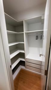 a walk in closet with white walls and wooden floors at Fogar de Breogan in A Coruña